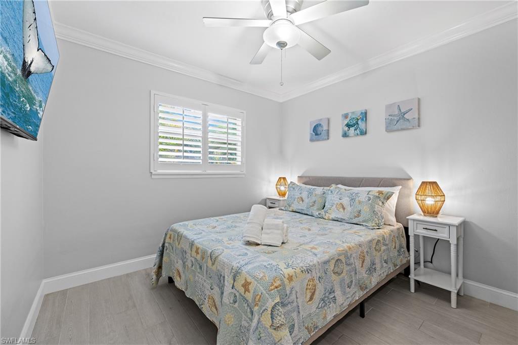 732 108th Avenue North Naples, FL 34108 - Photo 11 of 28 a bedroom with a bed and a table