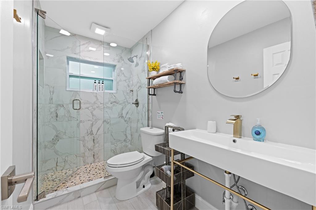 732 108th Avenue North Naples, FL 34108 - Photo 12 of 28 a bathroom with a sink a toilet and shower