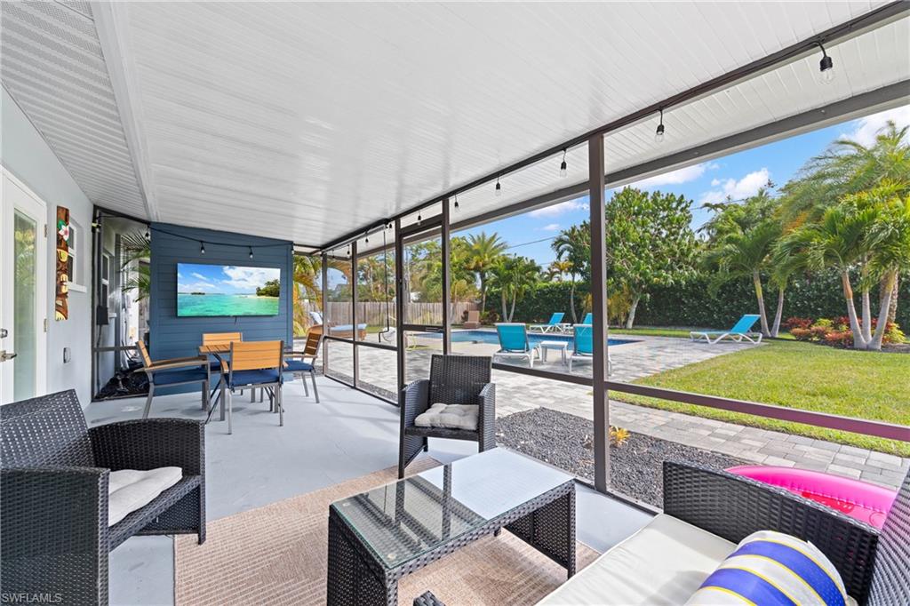 732 108th Avenue North Naples, FL 34108 - Photo 14 of 28 a living room with furniture and a large window