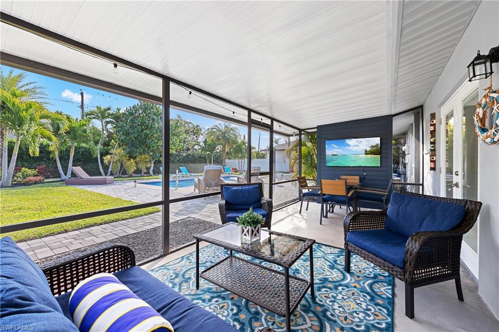 732 108th Avenue North Naples, FL 34108 - Photo 15 of 28 a living room with furniture and a floor to ceiling window