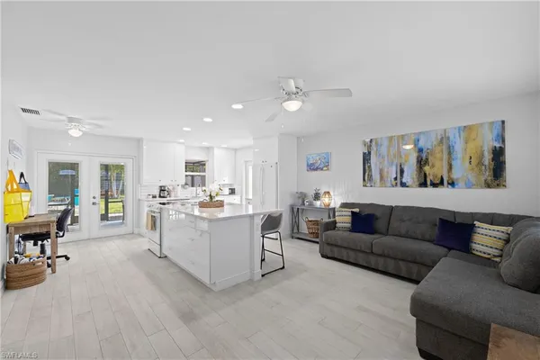 a living room with furniture and wooden floor