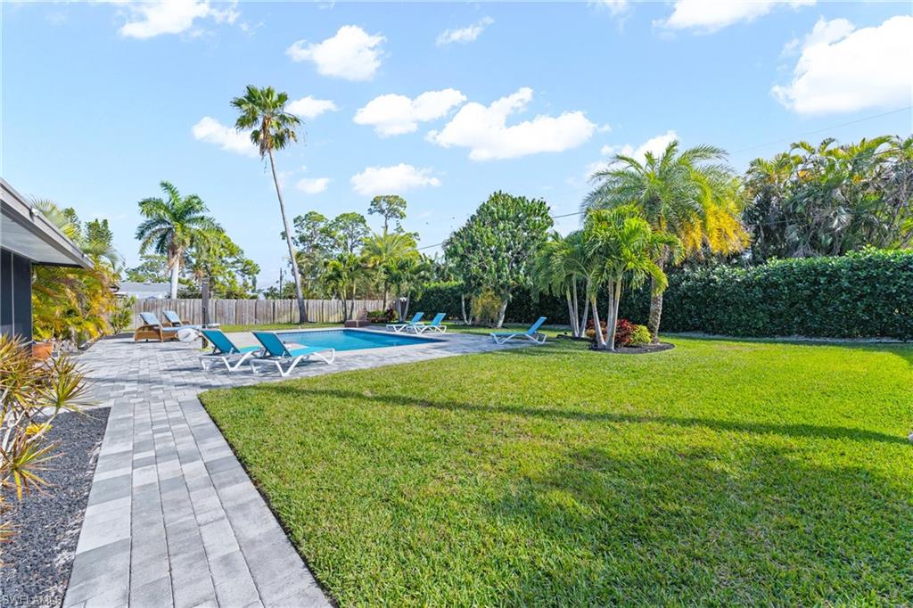 732 108th Avenue North Naples, FL 34108 - Photo 21 of 28 a view of a swimming pool with a garden