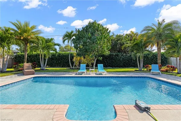 a view of swimming pool with lounge chair