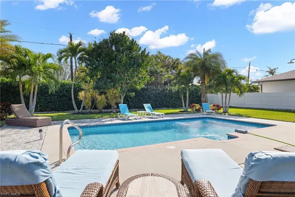 a view of a swimming pool with a lounge chairs
