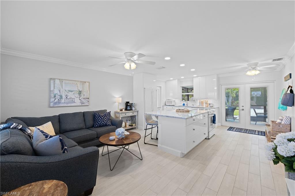 732 108th Avenue North Naples, FL 34108 - Photo 5 of 28 a living room with furniture and view of kitchen
