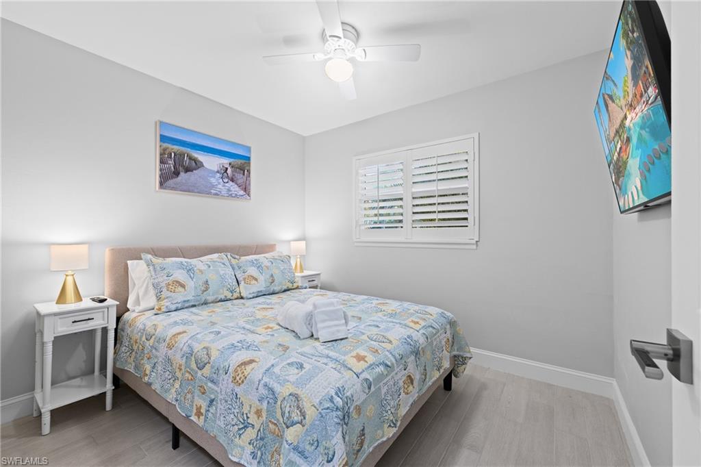 732 108th Avenue North Naples, FL 34108 - Photo 9 of 28 a bedroom with a bed and a painting on the wall