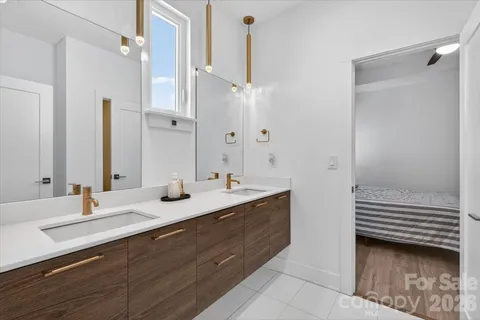 a en suite bathroom with double sink and a mirror