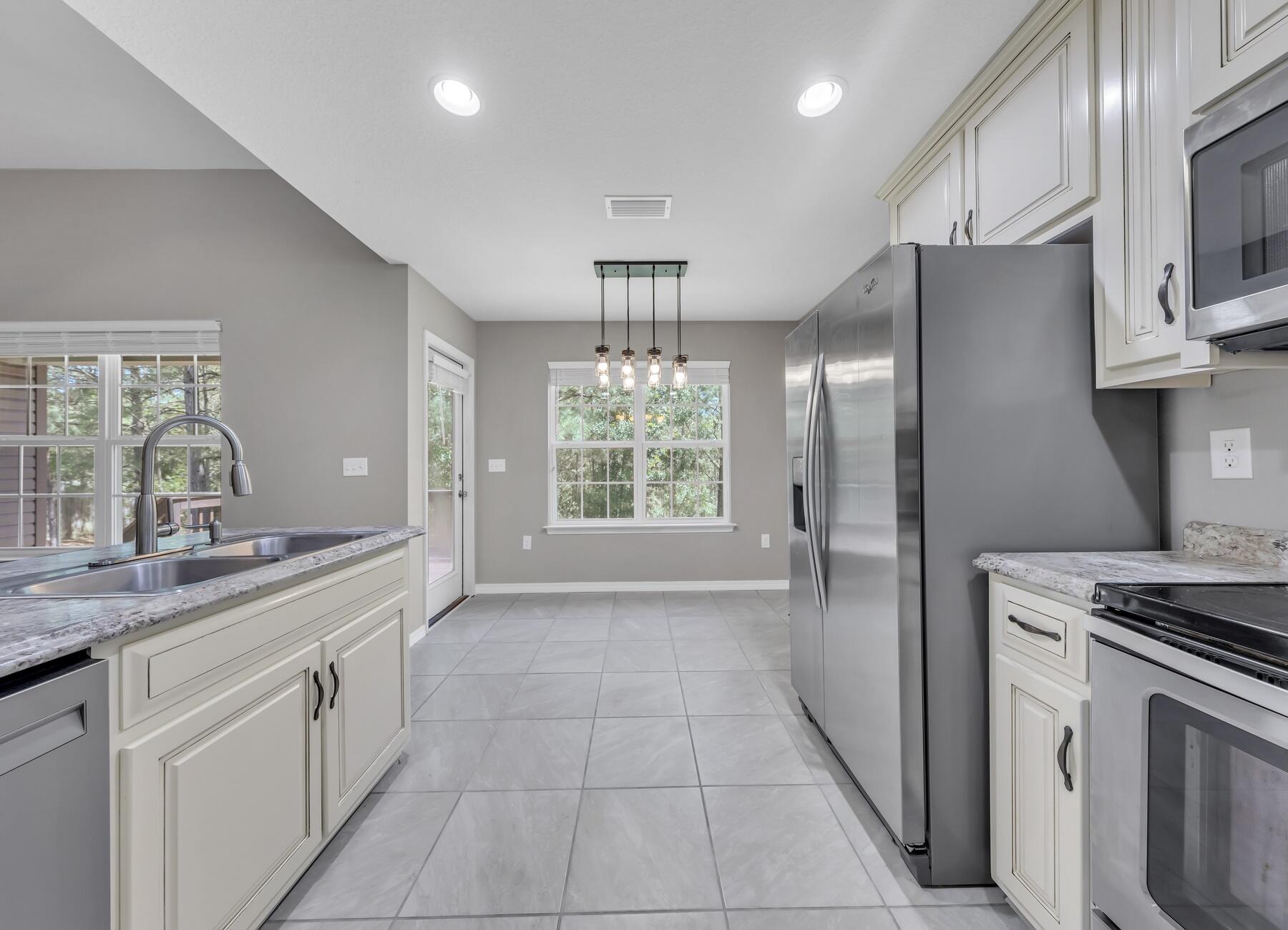 129 Fairway Drive Crestview, FL 32536 - Photo 1 of 30 a kitchen with a sink stove and refrigerator