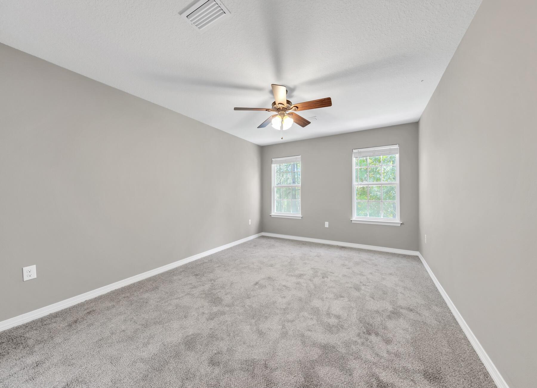 129 Fairway Drive Crestview, FL 32536 - Photo 14 of 30 an empty room with windows and fan