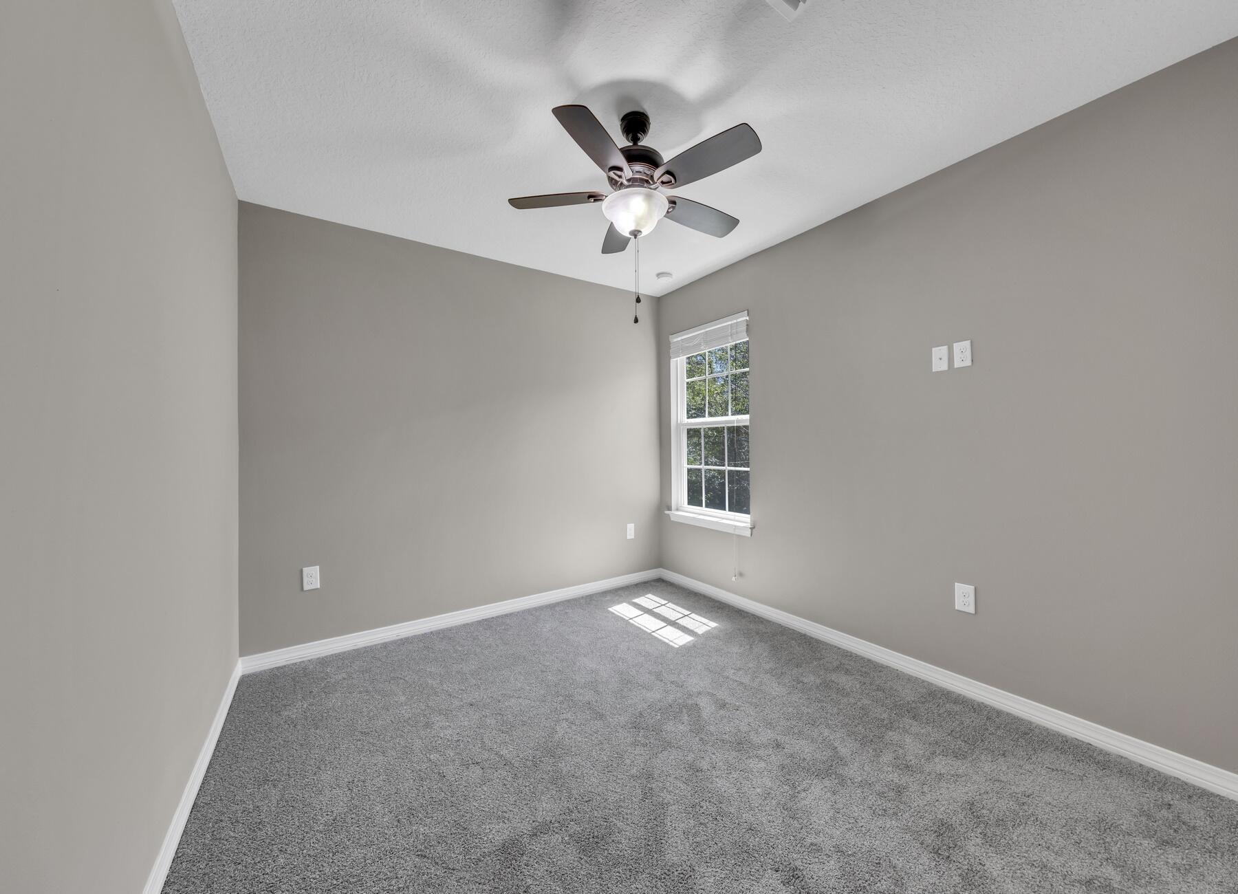 129 Fairway Drive Crestview, FL 32536 - Photo 24 of 30 an empty room with window and ceiling fan