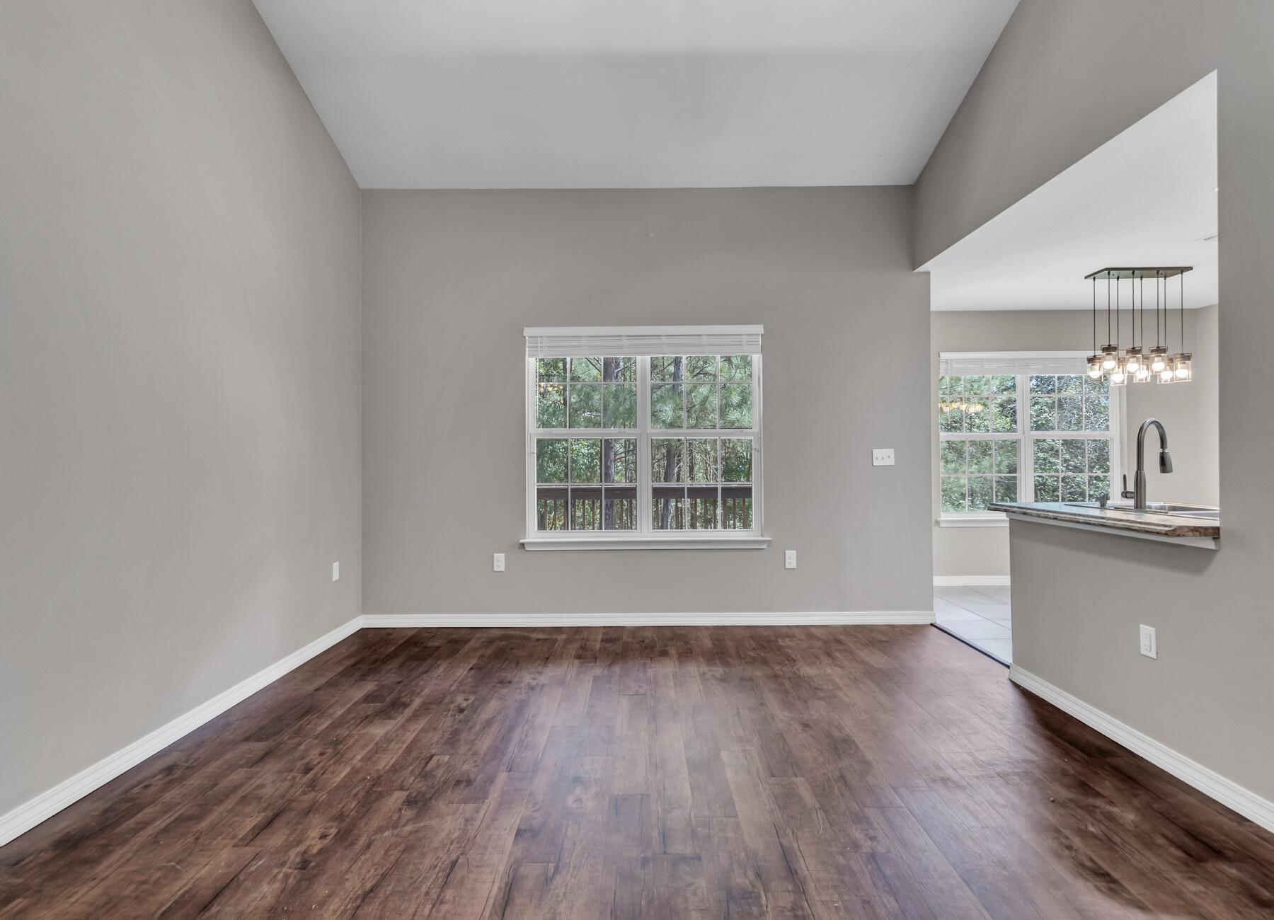 129 Fairway Drive Crestview, FL 32536 - Photo 5 of 30 a view of an empty room with wooden floor and a window