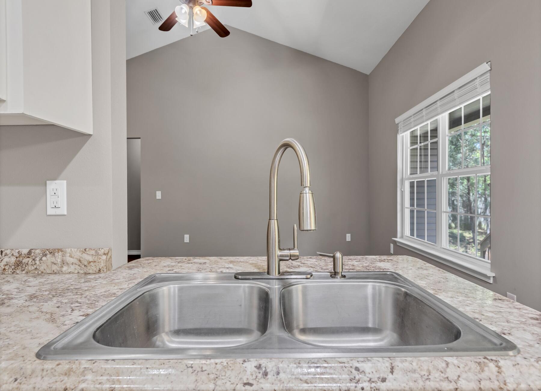 129 Fairway Drive Crestview, FL 32536 - Photo 10 of 30 a view with a sink and a large mirror next to a window