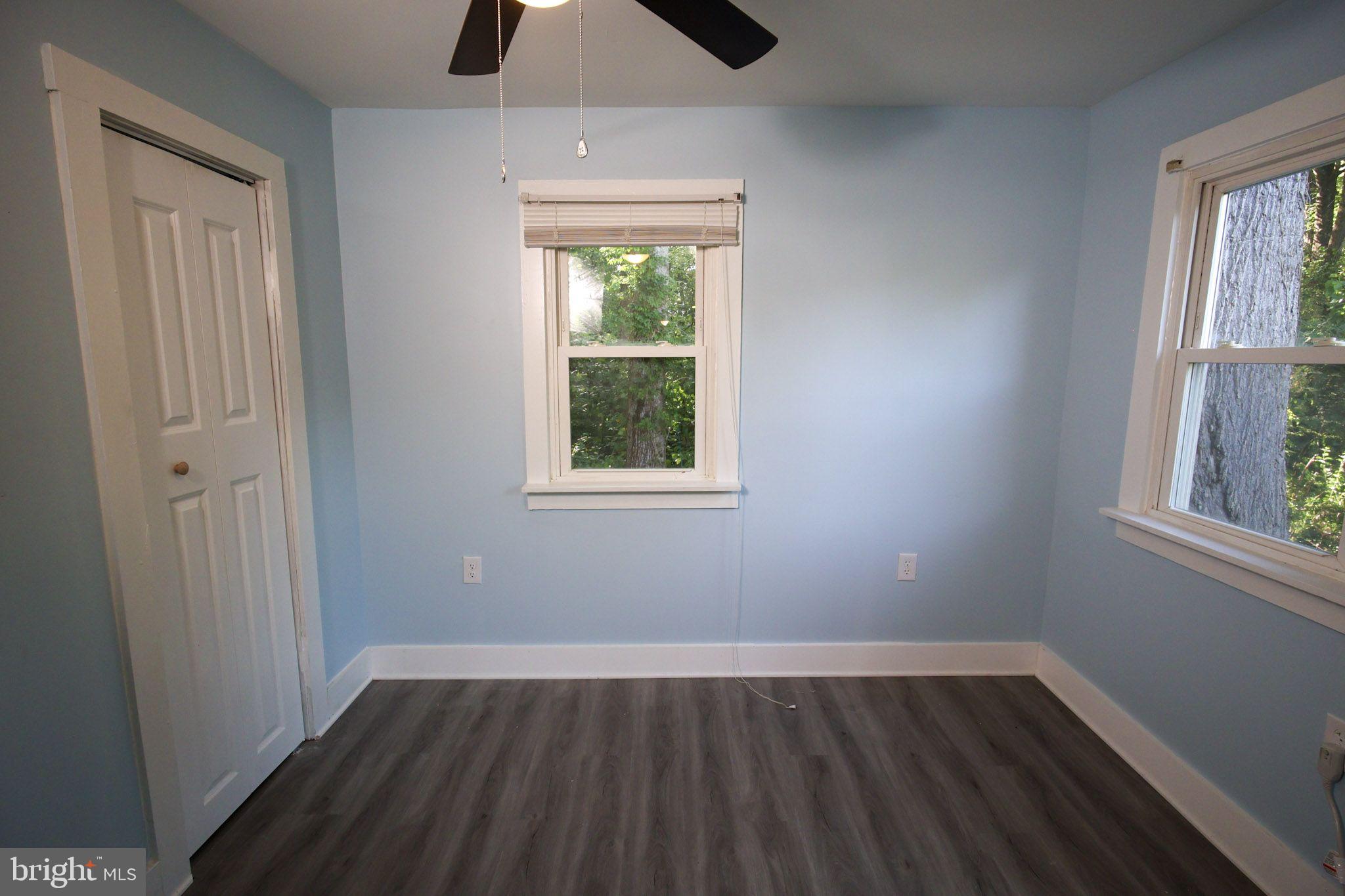 439 Peckatone Road Kinsale, VA 22488 - Photo 14 of 15 an empty room with wooden floor and windows