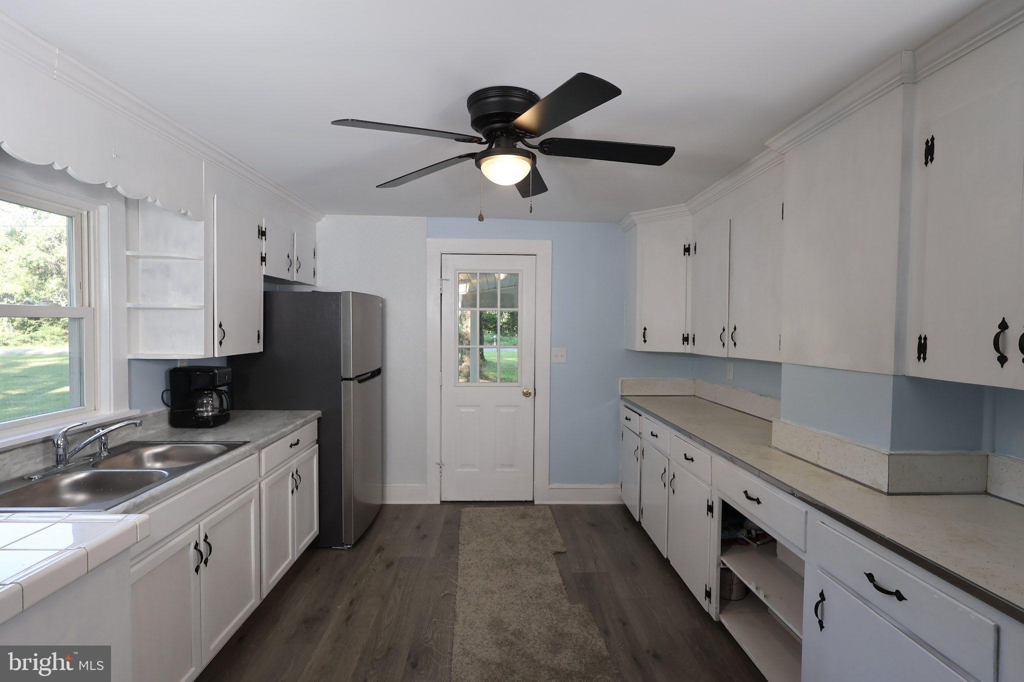 439 Peckatone Road Kinsale, VA 22488 - Photo 5 of 15 a kitchen with stainless steel appliances granite countertop a sink a stove a refrigerator a chimney a refrigerator and cabinets