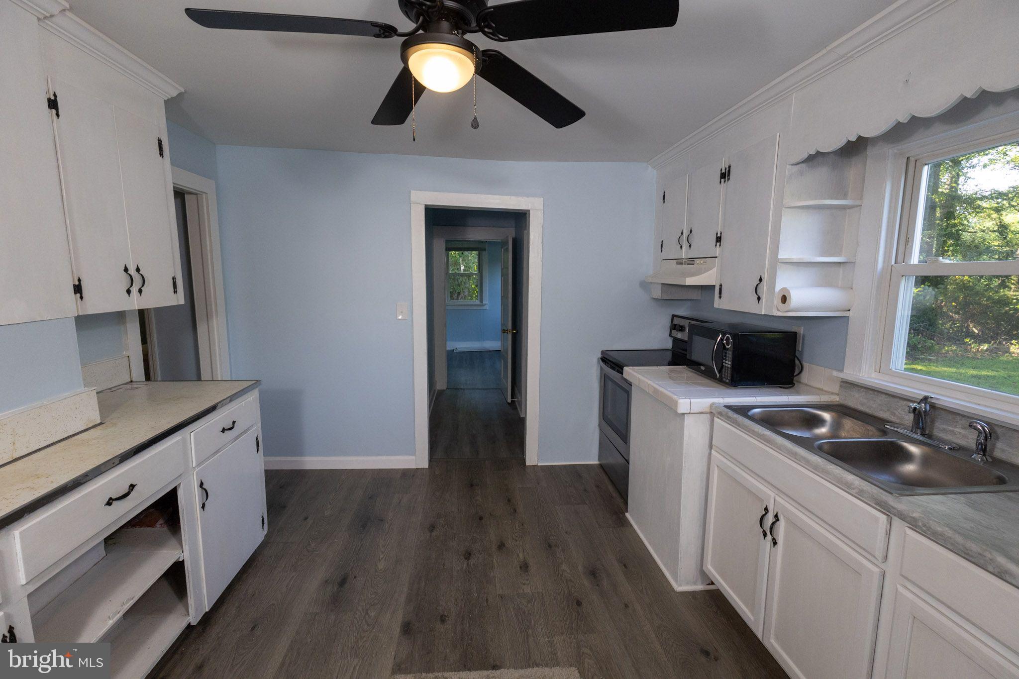 439 Peckatone Road Kinsale, VA 22488 - Photo 6 of 15 a kitchen with a stove and a wooden floor