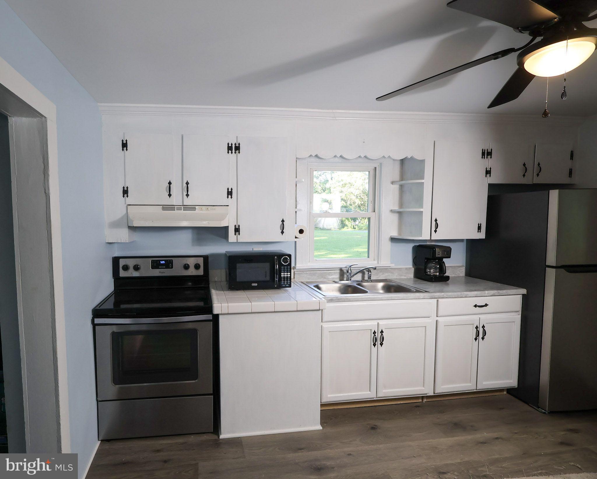 439 Peckatone Road Kinsale, VA 22488 - Photo 7 of 15 a kitchen with a sink stove and refrigerator