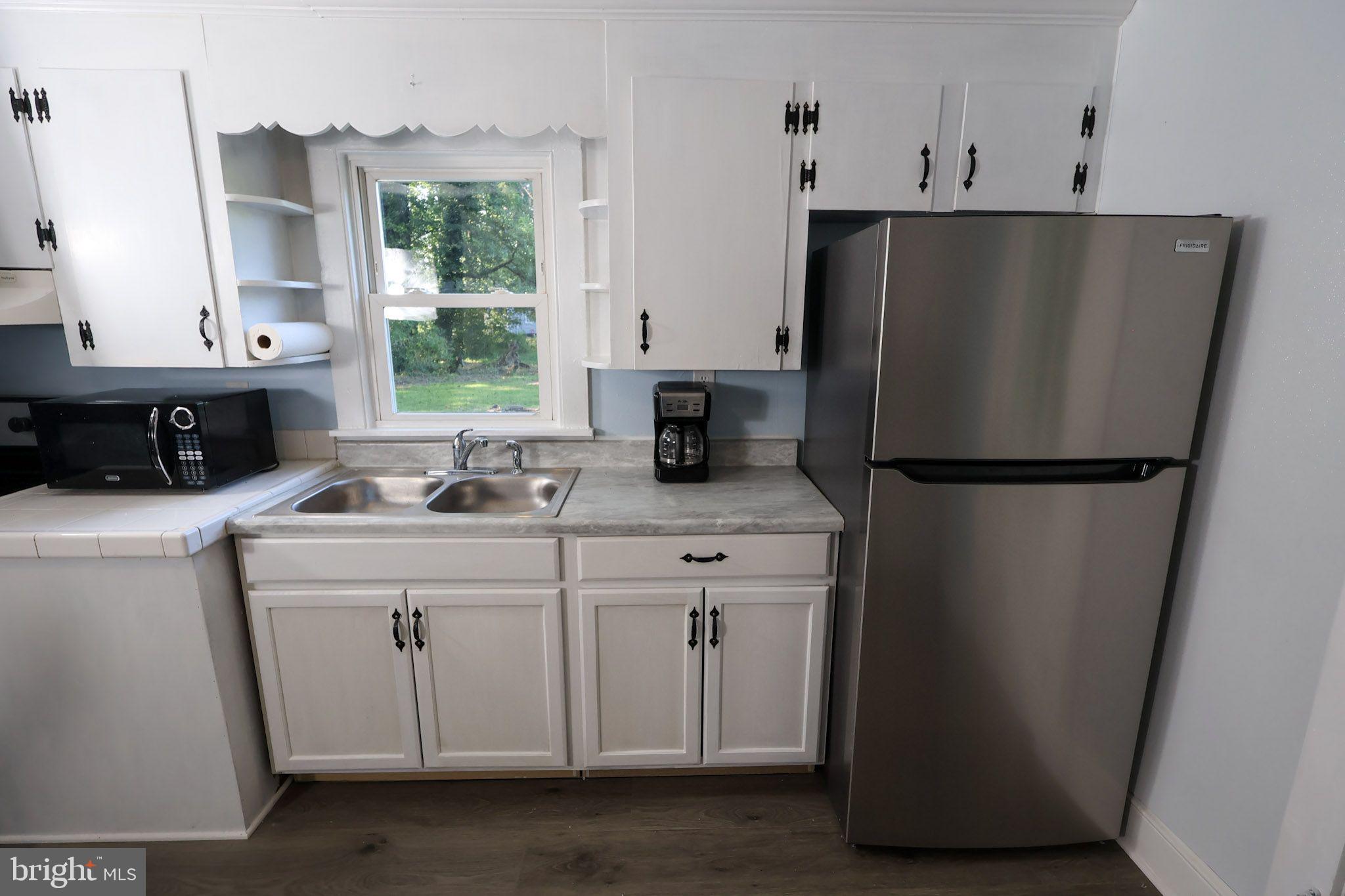 439 Peckatone Road Kinsale, VA 22488 - Photo 8 of 15 a kitchen with stainless steel appliances a refrigerator sink and cabinets