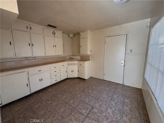 a view of a kitchen with white cabinets