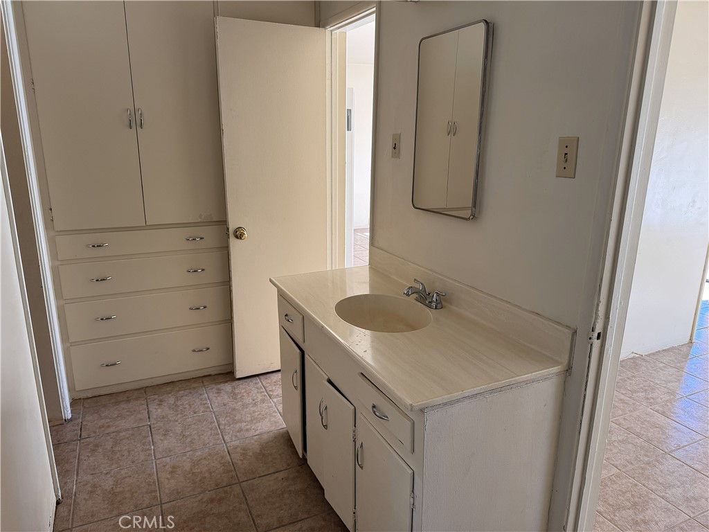 521 East Williams Street Barstow, CA 92311 - Photo 21 of 25 a bathroom with a sink and a mirror