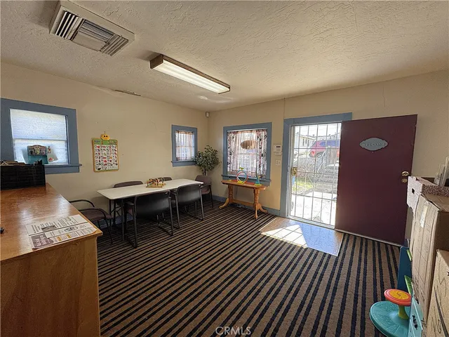 a living room with furniture a rug and a floor to ceiling window