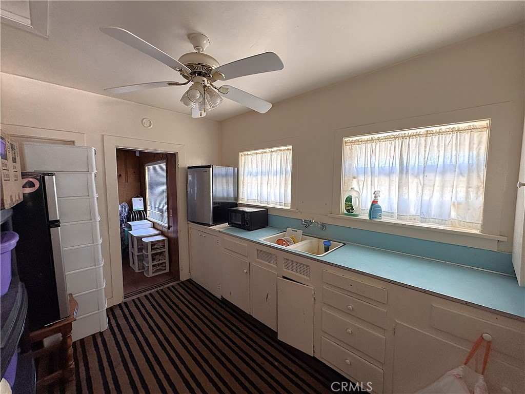 521 East Williams Street Barstow, CA 92311 - Photo 7 of 25 a kitchen with a sink stove and refrigerator