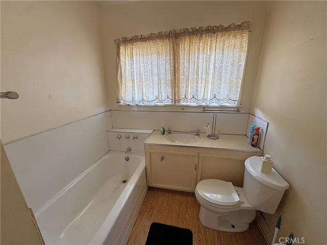 a bathroom with a sink a toilet and bathtub
