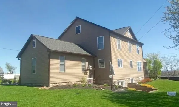 a front view of house with a garden