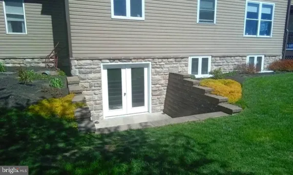 a view of a house with a yard and sitting area