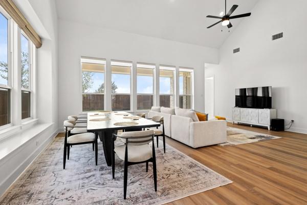 1825 Rough Rdg Trail Midlothian, TX 76065 - Photo 14 of 37 Spacious open-concept living area featuring a vaulted ceiling with a ceiling fan, abundant natural light from multiple windows, and wide wood-finish flooring