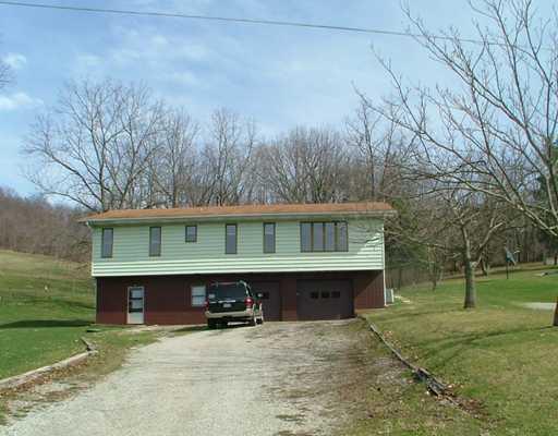 Exterior Front. Raised ranch in quiet country setting with oversized garage (14 course block), 28 feet deep and two 7 3"x10  garage doors. Additional garage/work shop/storage area accessible from the side yard, and lots of off street parking!