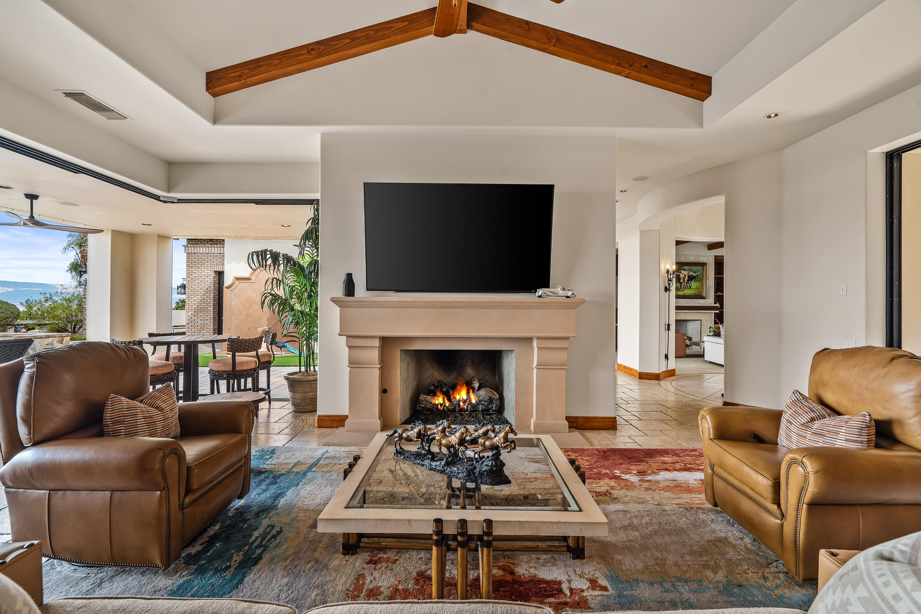 31 Hillcrest Drive Rancho Mirage, CA 92270 - Photo 21 of 82 a living room with furniture a flat screen tv and a fireplace