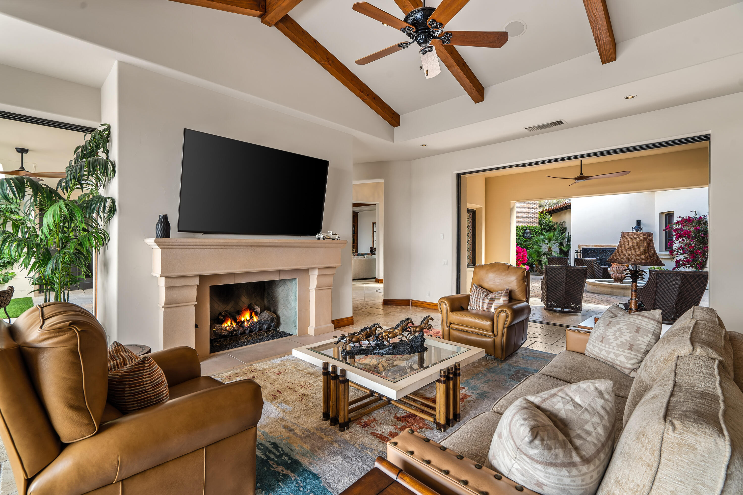 31 Hillcrest Drive Rancho Mirage, CA 92270 - Photo 22 of 82 a living room with furniture a flat screen tv and a fireplace