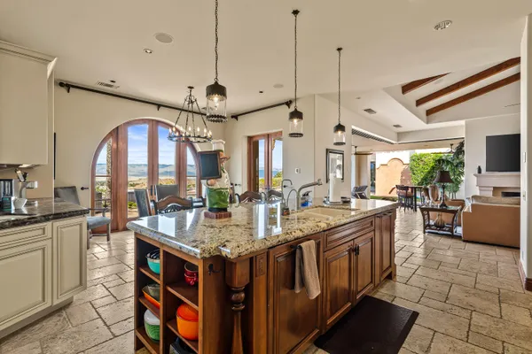 a spacious bedroom with bed and a large mirror on the dresser
