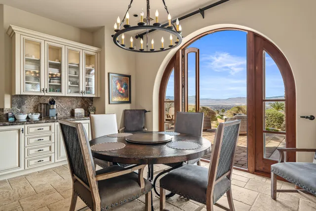 a bedroom with a bed a fireplace and a flat tv screen
