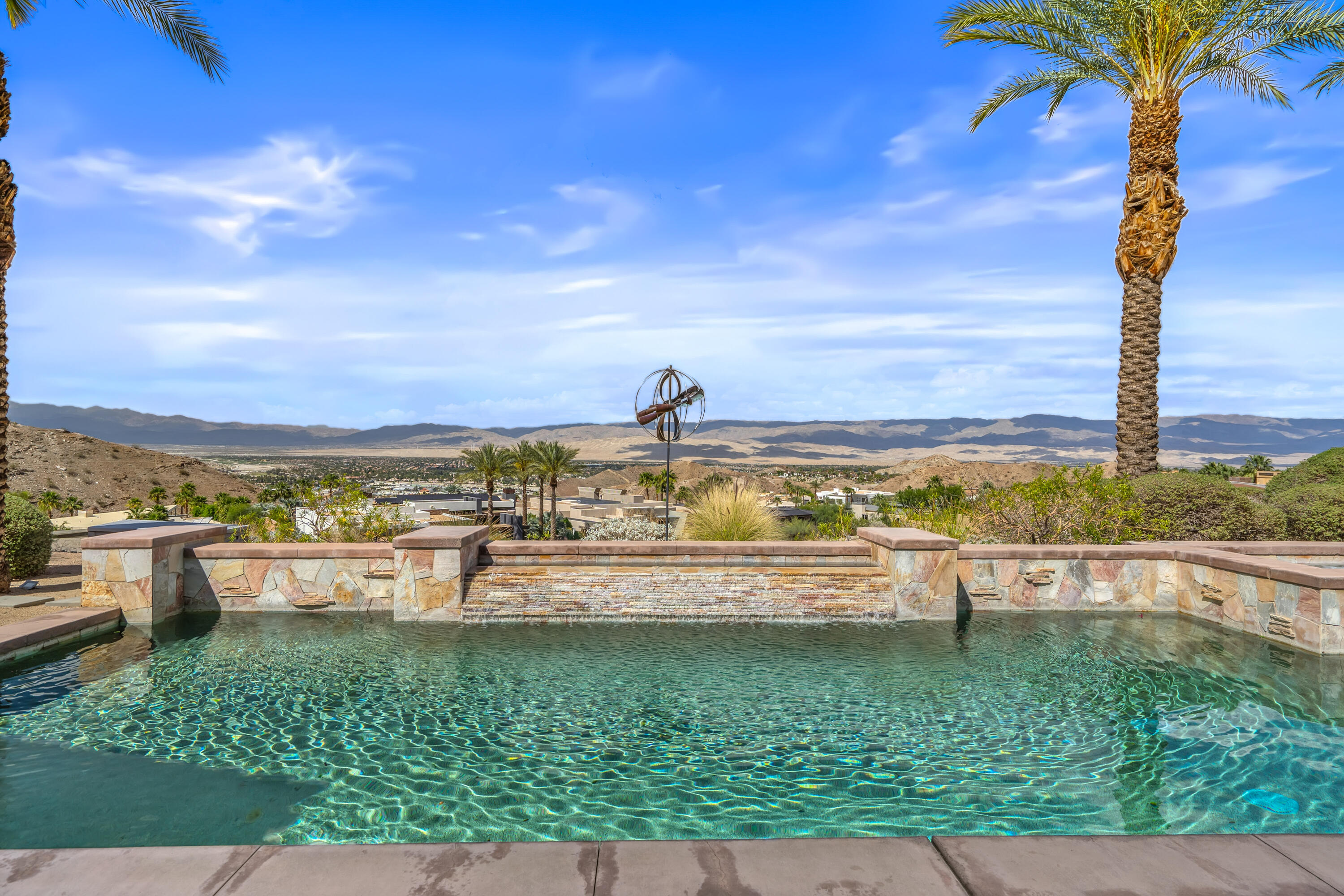 31 Hillcrest Drive Rancho Mirage, CA 92270 - Photo 4 of 82 a view of a swimming pool with a garden