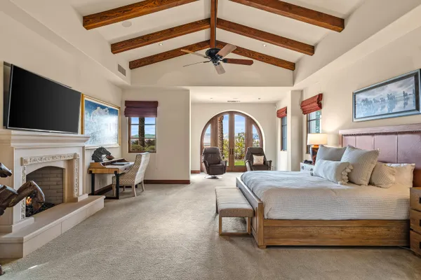 a view of a livingroom with furniture and floor to ceiling window