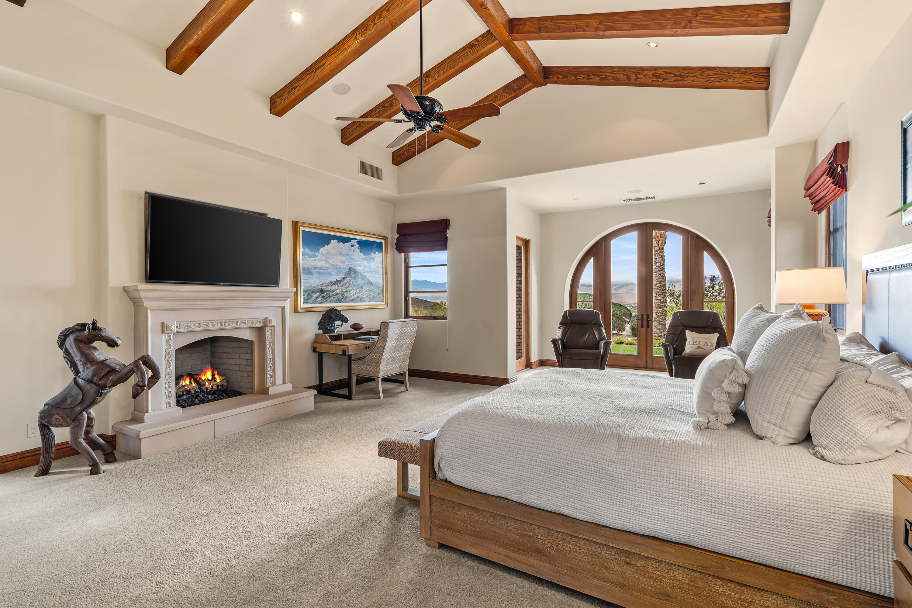 31 Hillcrest Drive Rancho Mirage, CA 92270 - Photo 43 of 82 a bedroom with a bed a fireplace and a flat tv screen