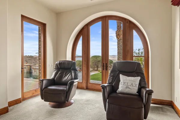 a view of a house with backyard porch and sitting area