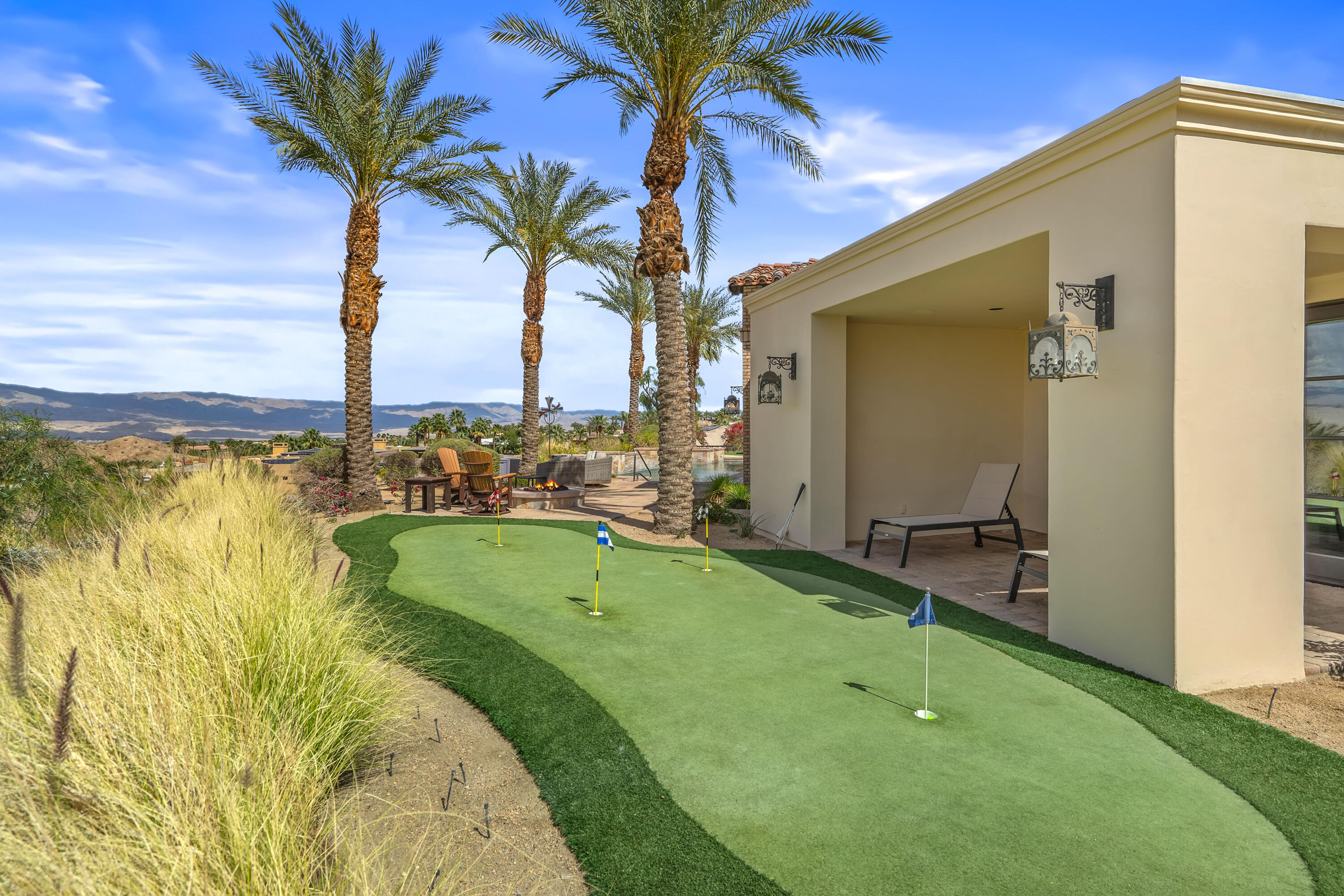 31 Hillcrest Drive Rancho Mirage, CA 92270 - Photo 79 of 82 a view of a swimming pool with a table and chairs