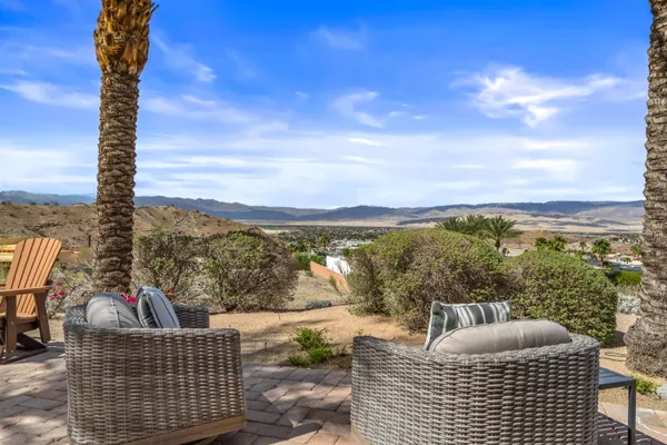 a view of a patio with table and chairs and potted plants