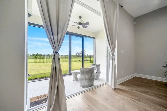 a view of an entryway with wooden floor and door
