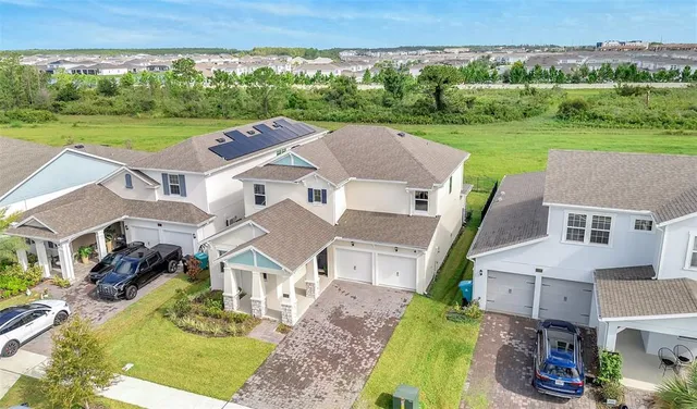 an aerial view of a house with big yard