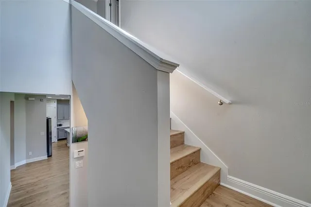 a view of entryway and hall with wooden floor