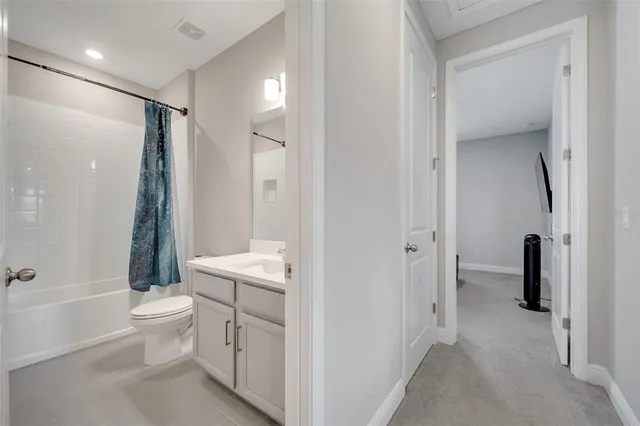 a bathroom with a toilet sink and a mirror