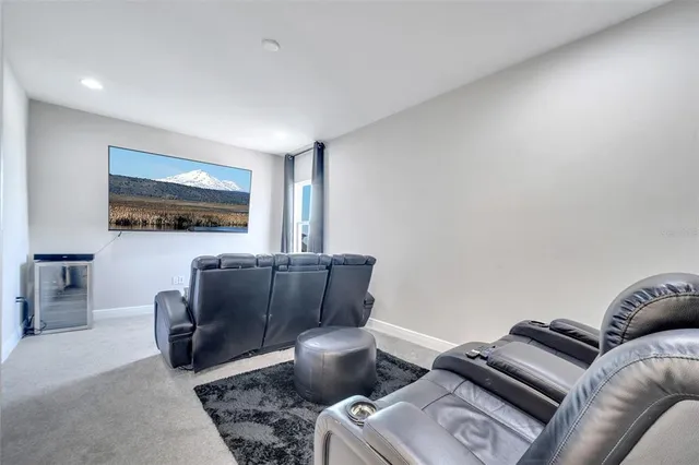 a living room with furniture a couch and a flat screen tv