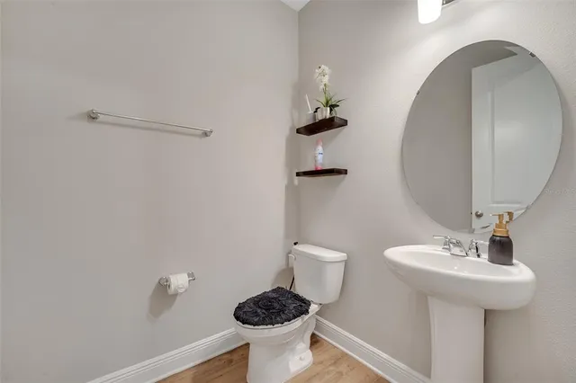 a bathroom with a sink toilet and a mirror