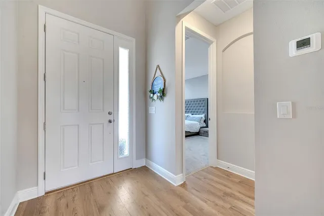 a view of livingroom with hallway and wooden floor