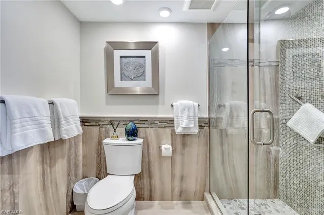 a bathroom with a toilet sink and shower