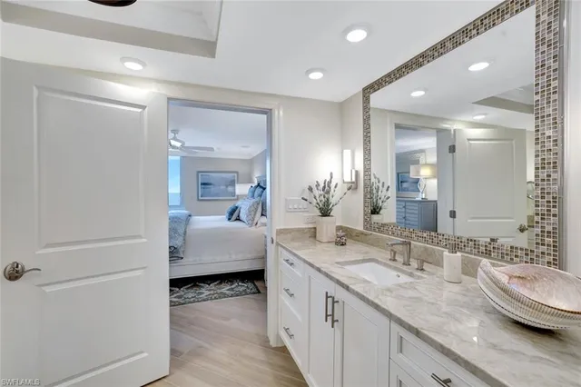 a en suite bathroom with a double vanity sink and a mirror