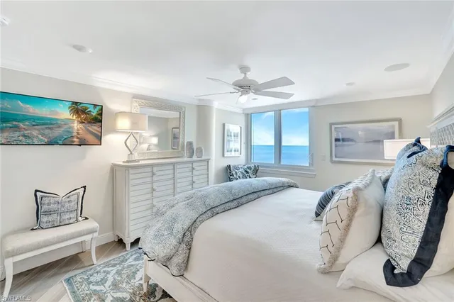 a spacious bedroom with a bed and a chandelier